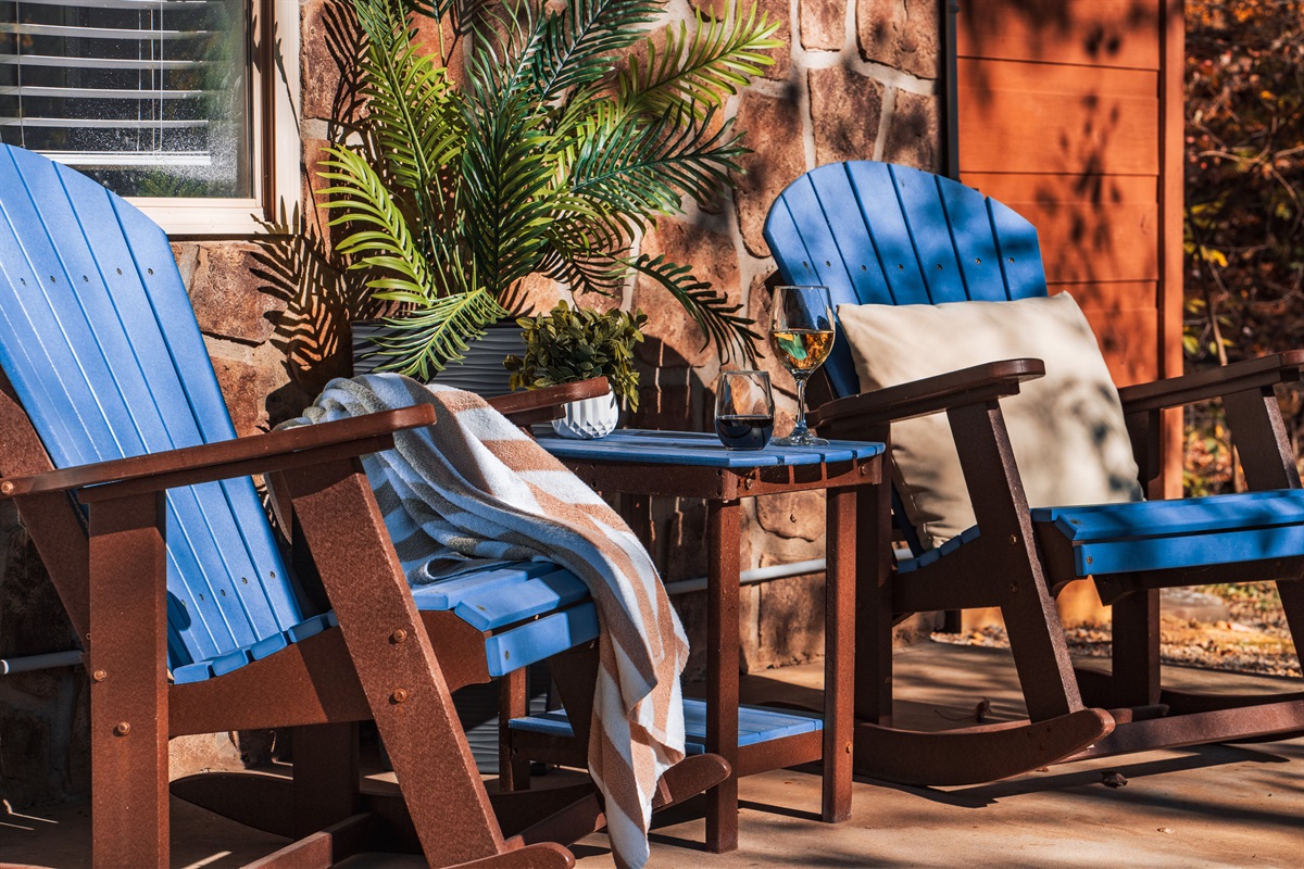 A porch with two chairs provides relaxation and in-nature entertainment.