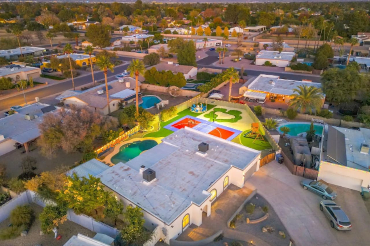 A backyard built for a crowd: pool, sport court, and putting green, all on one oversized lot.