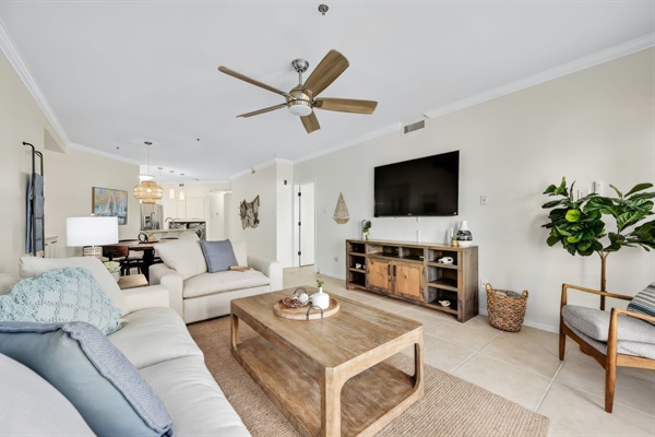 Open-concept dining and living space with natural light, modern coastal decor, and room to gather comfortably.