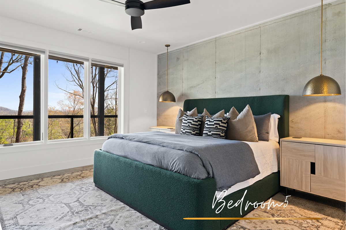Contemporary vibes meet nature's tranquility in this room, where comfort and style invite restful slumber with a view.