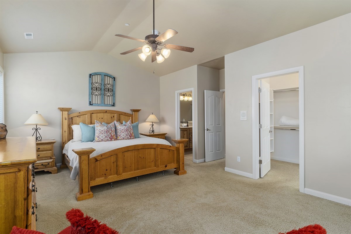 Airy primary suite with vaulted ceilings, warm finishes, and a relaxing, open feel.