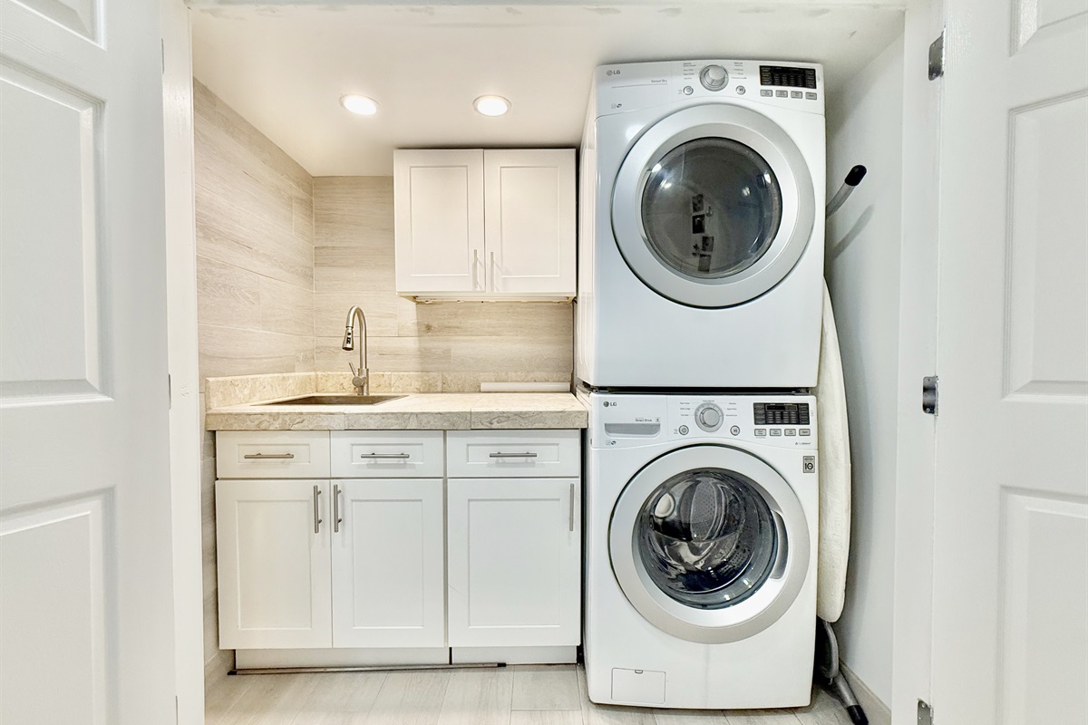 On your left, across from the bottom of the stairs is the washer/dryer laundry area.