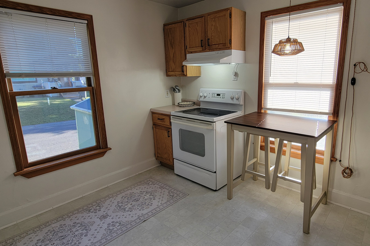 Kitchen with stove, extra prep space, and a small table for coffee, snacks, or planning the day.