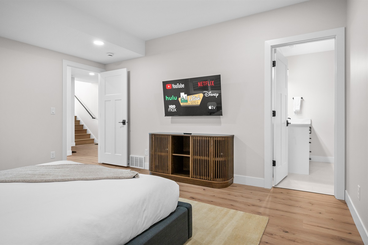 Spacious lower-level bedroom layout with easy access to stairs and bath.