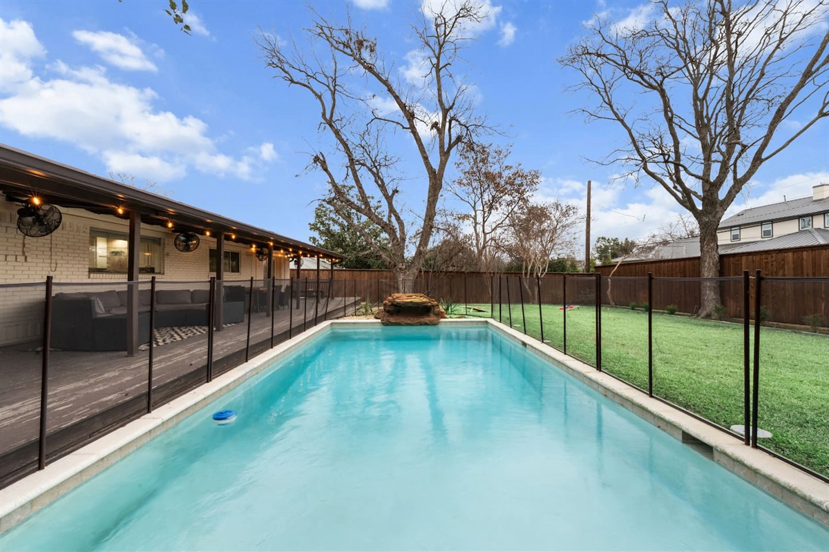 Cool off in your private pool with child-safe fencing and a serene backyard—perfect for relaxing or play.