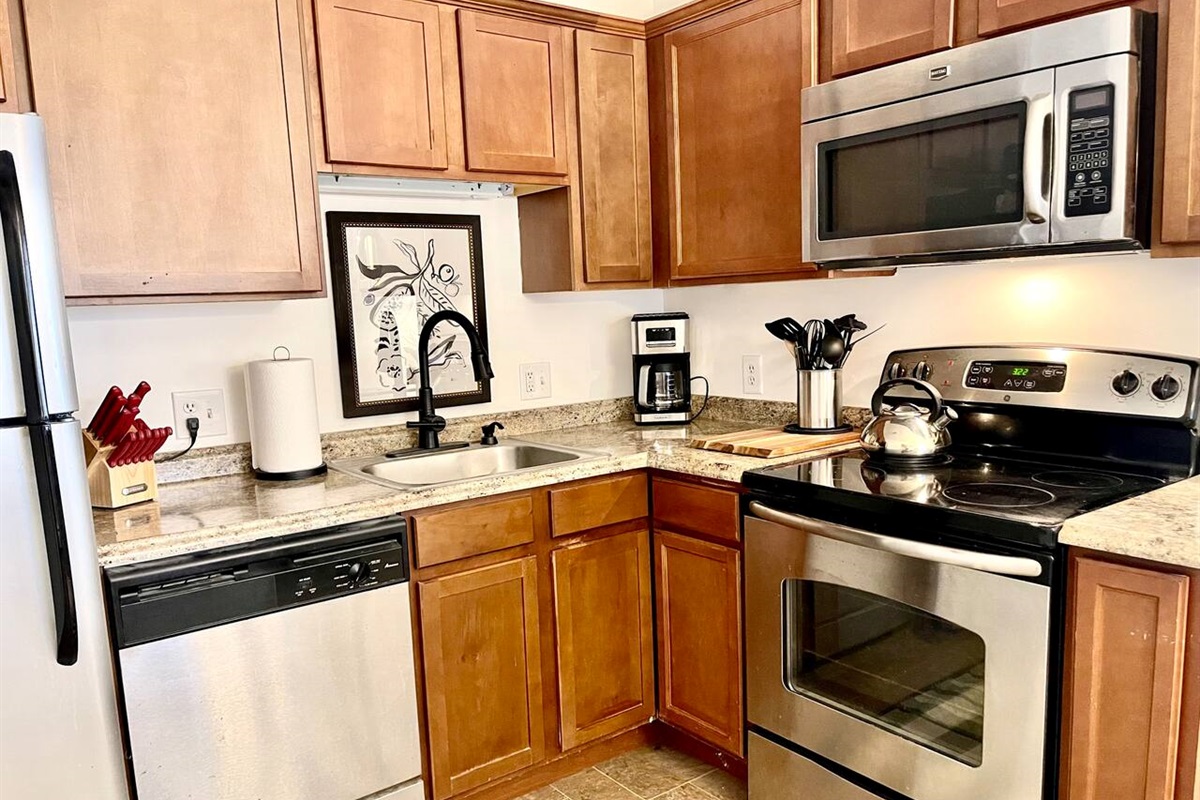 This bright, functional kitchen features SS appliances, a full set of cooking essentials, granite-style counters, and modern decor. Whether you're preparing a quick breakfast or a full dinner, this space is equipped to make your stay comfortable.