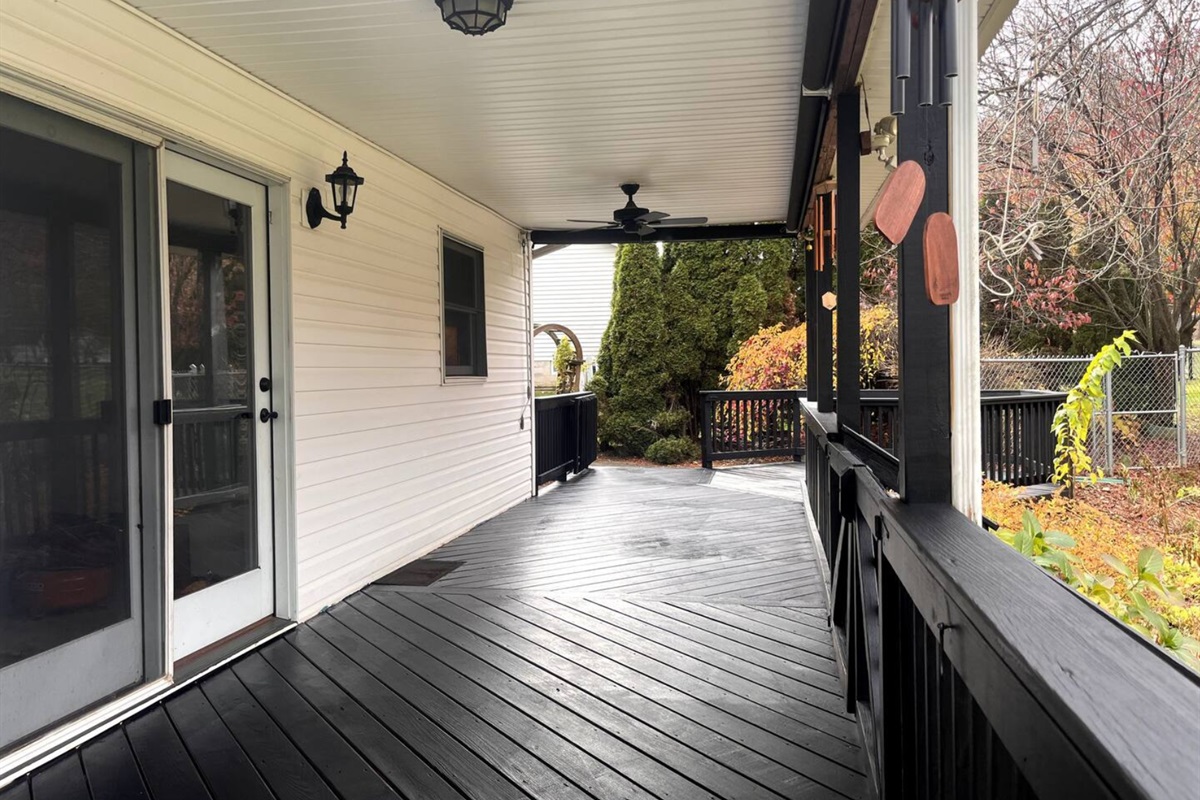 Full length porch with large fenced in back yard