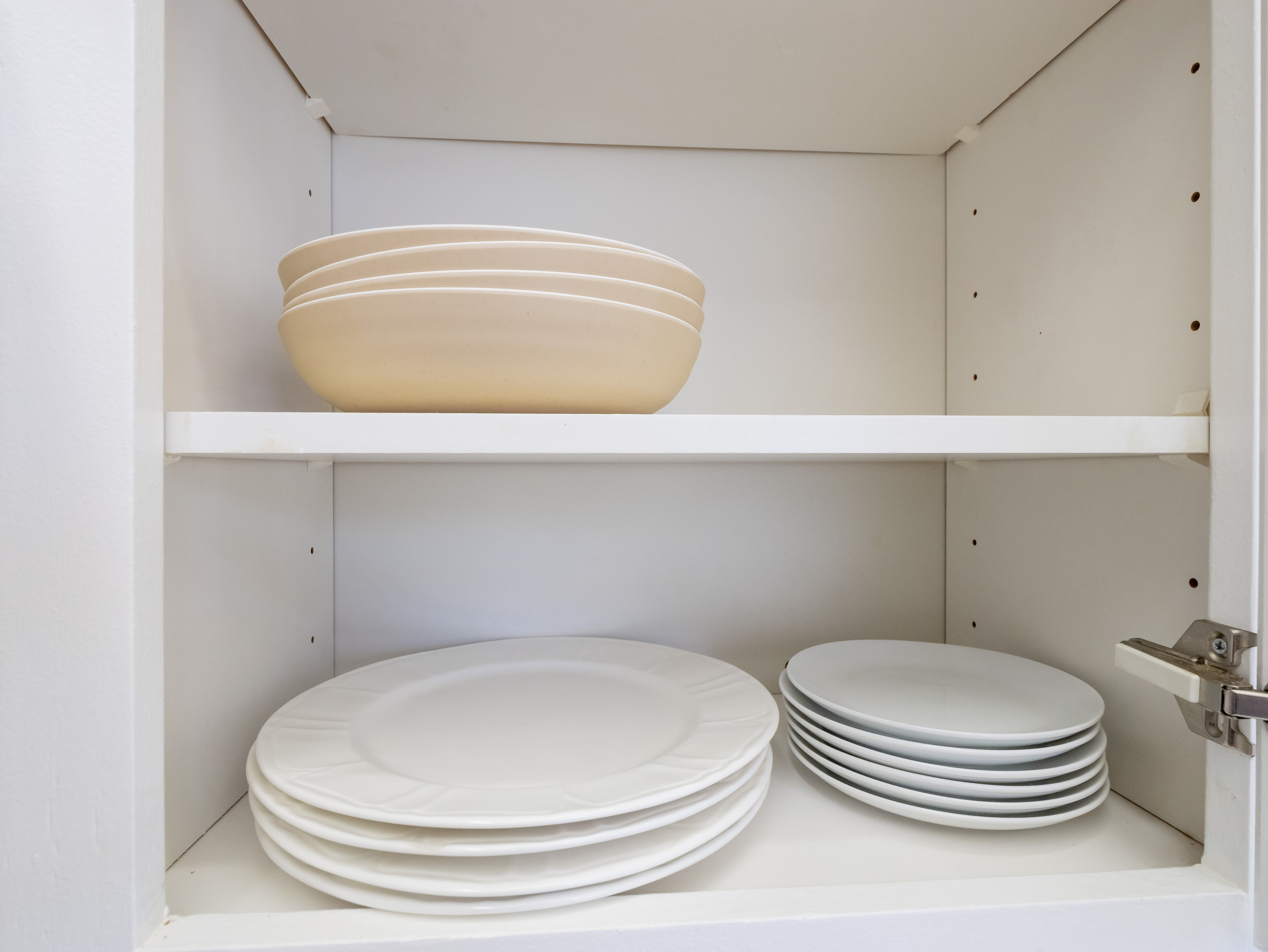 The kitchen is fully stocked with plates, bowls, and everyday dining essentials, making it easy to enjoy meals together during your stay.