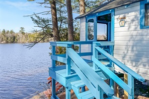 stairs that leads to the screeened porch with lake view