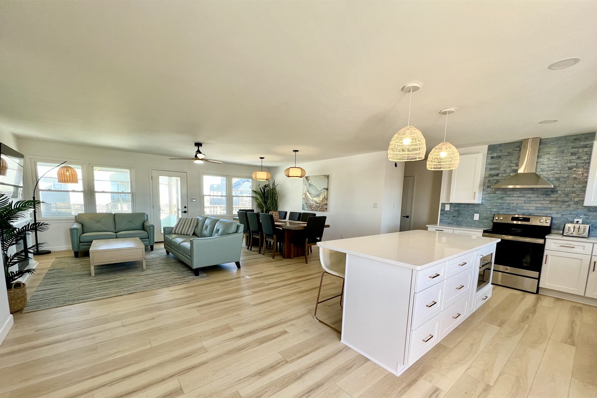 Open floor plan with a large dining area, island, and TV area