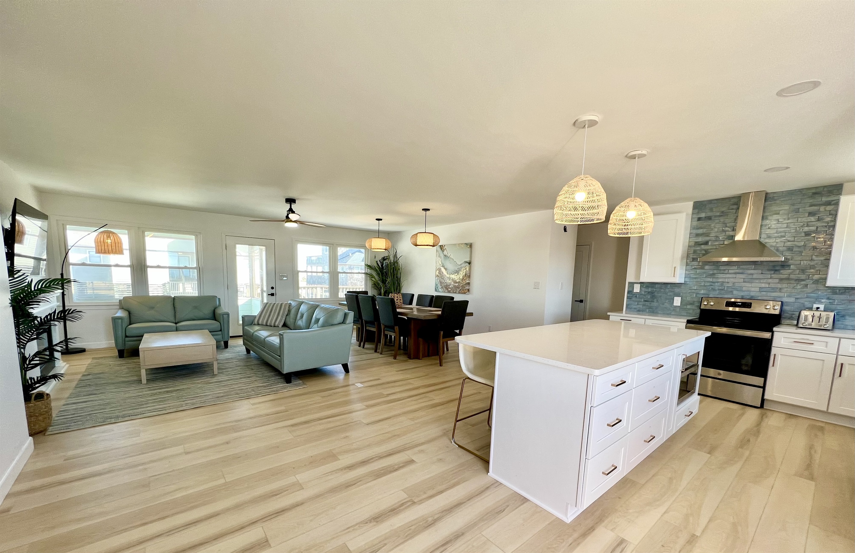 Open floor plan with a large dining area, island, and TV area