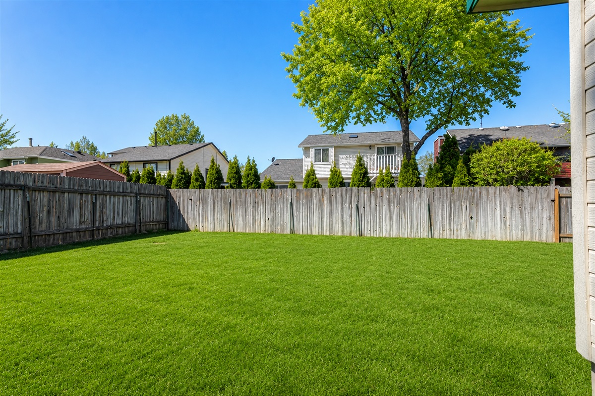 Apt. 1: Large partially fenced front/side yard.