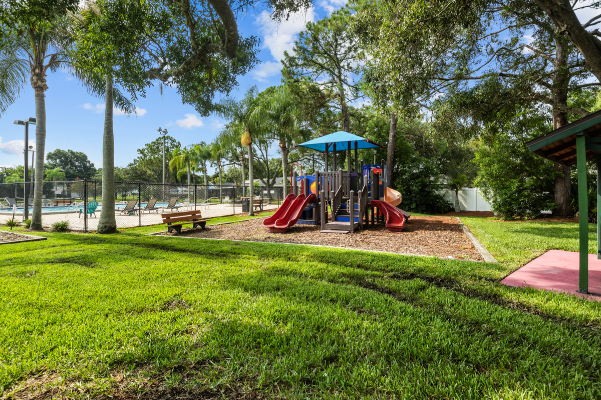 The recreation area playground is near the pool.