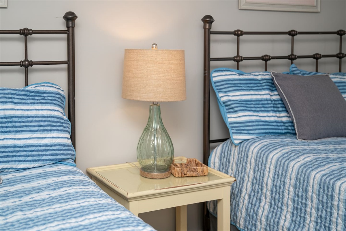 Two double beds in this cozy “cottage” feel bedroom.  Ceiling fan and TV.  Share a brand new full bathroom with bedroom number 2.  