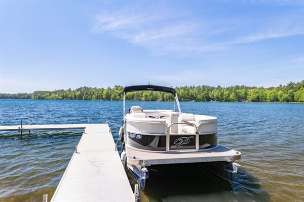 Clear lake with the pontoon waiting for you to take your family out for a cruse.