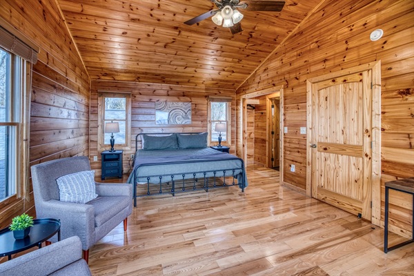One of the 2 upstairs bedrooms, both with a king bed, private bathroom, and sleeping nook sitting in a huge window with stunning mountain views!