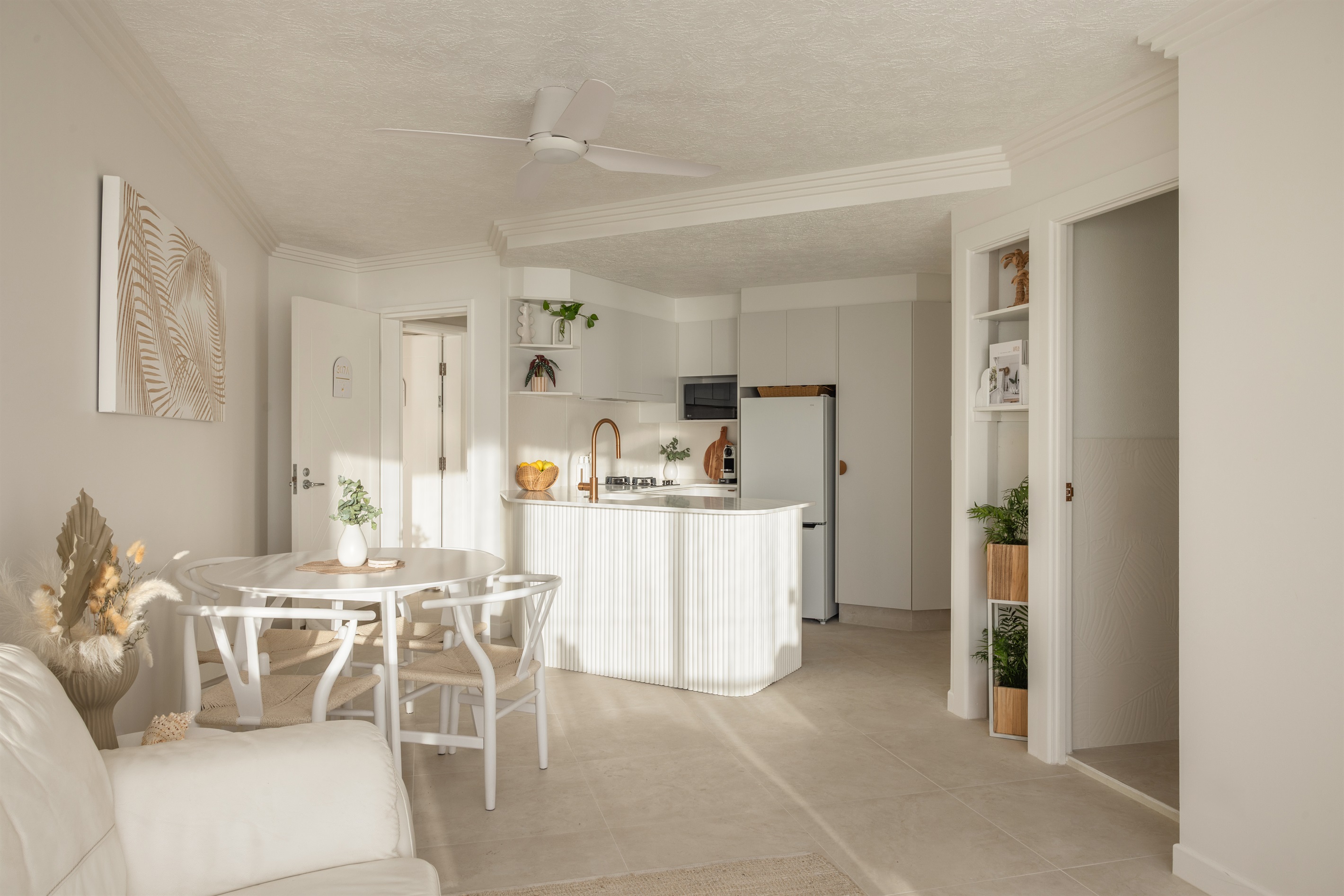 Open-plan coastal living with a beautifully styled kitchen & dining space.
