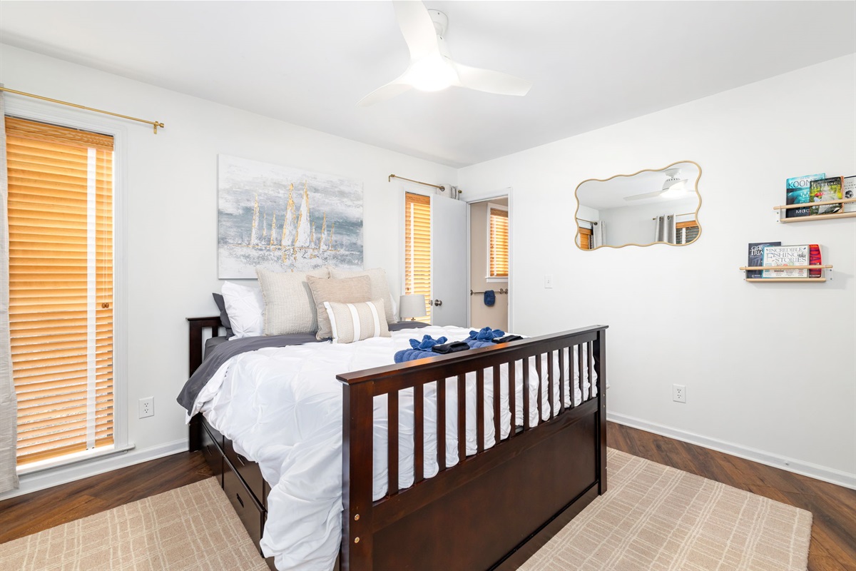 Queen Bedroom 2 with Trundle: Stylish decor and bright windows create the perfect ambiance for restful nights!