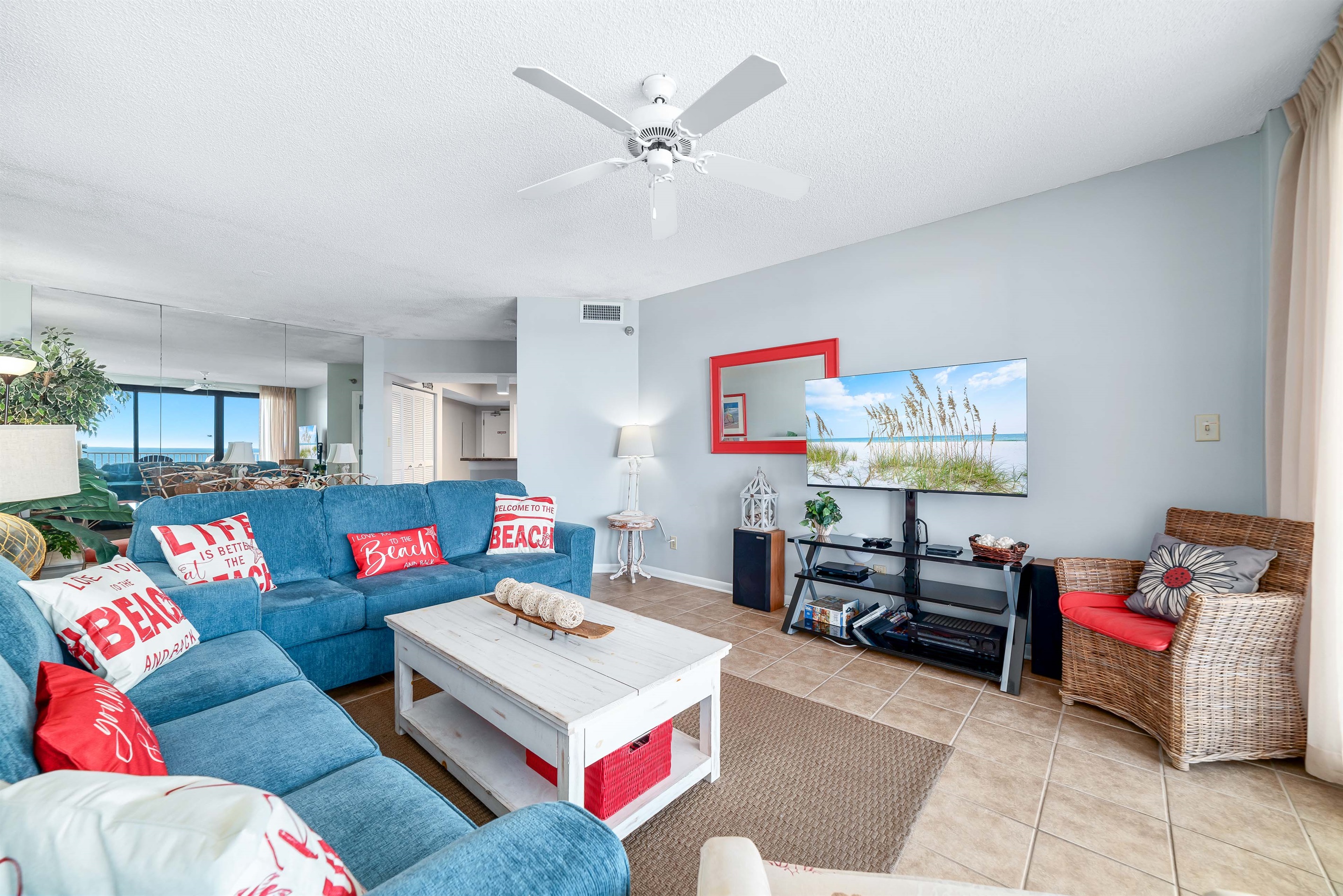 Experience the epitome of coastal living in this beautifully designed living room. Featuring plush furnishings, a serene color palette, and expansive views, this space offers a tranquil retrea
