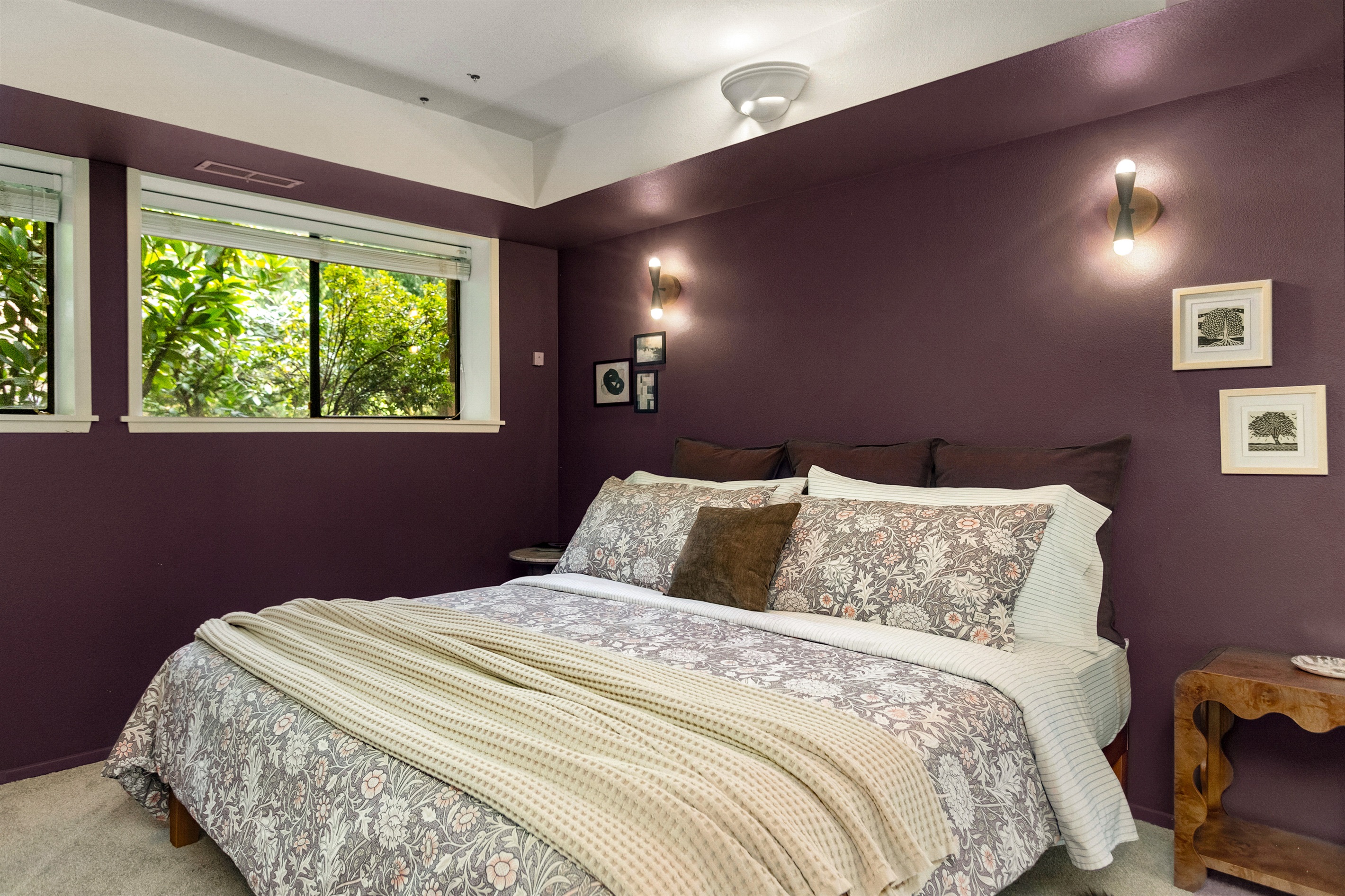 The huge secondary bedroom suite downstairs features green views out every window.