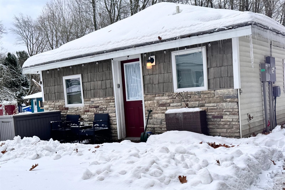 Charming snow covered entrance welcoming you to your cozy winter getaway