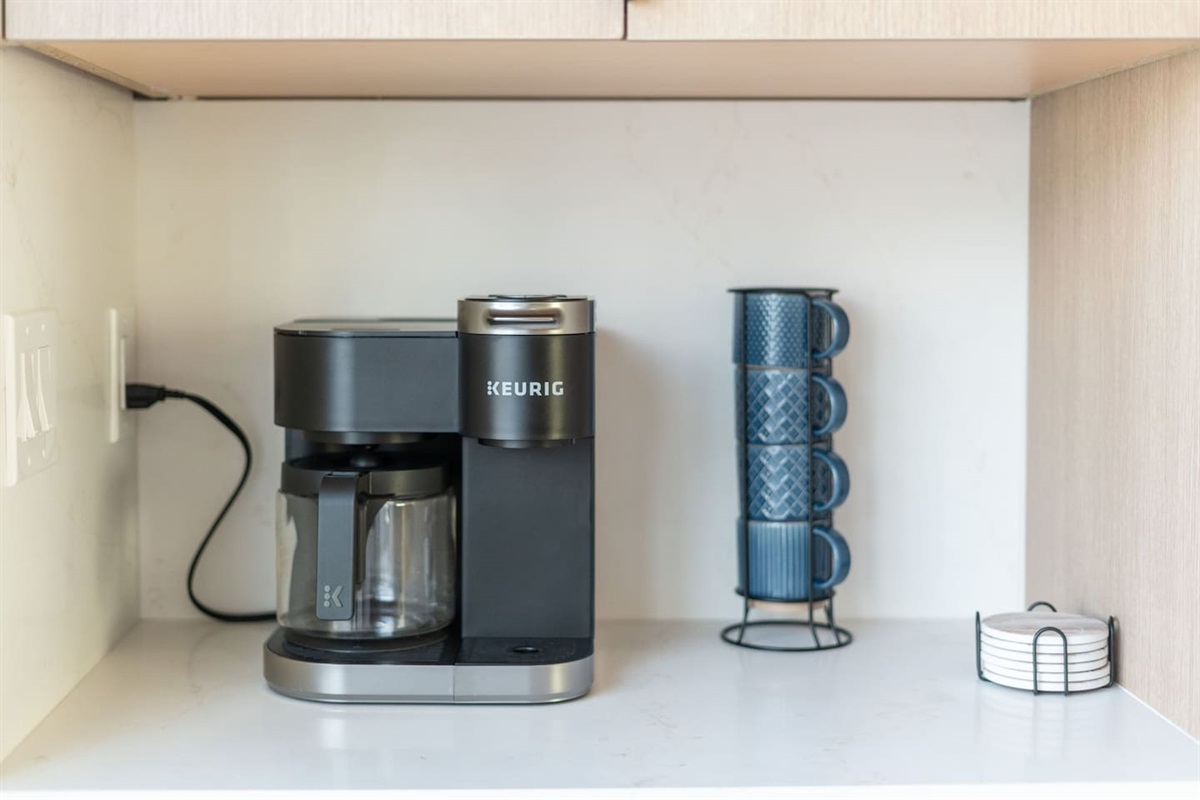 Coffee station with Keurig machine, mugs, and everything you need for your morning brew.