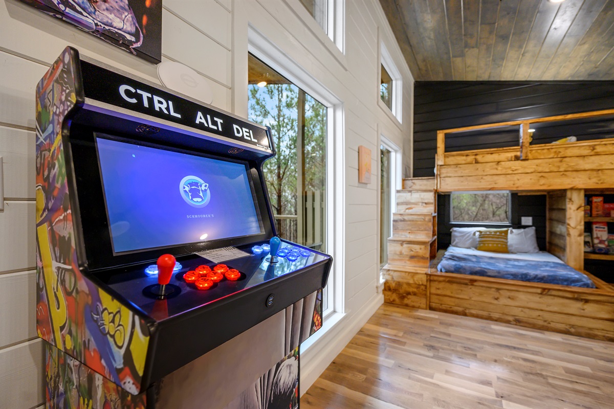 A lively bunk room entertainment corner featuring over 100 arcade-style games, creating the perfect hangout spot for friendly competition, laughter, and unforgettable group moments after a day of adventure. 🎮