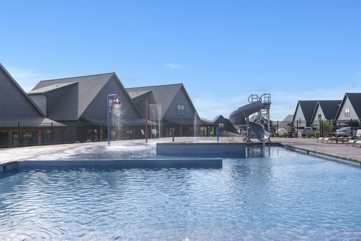 Large outdoor community pool with slide