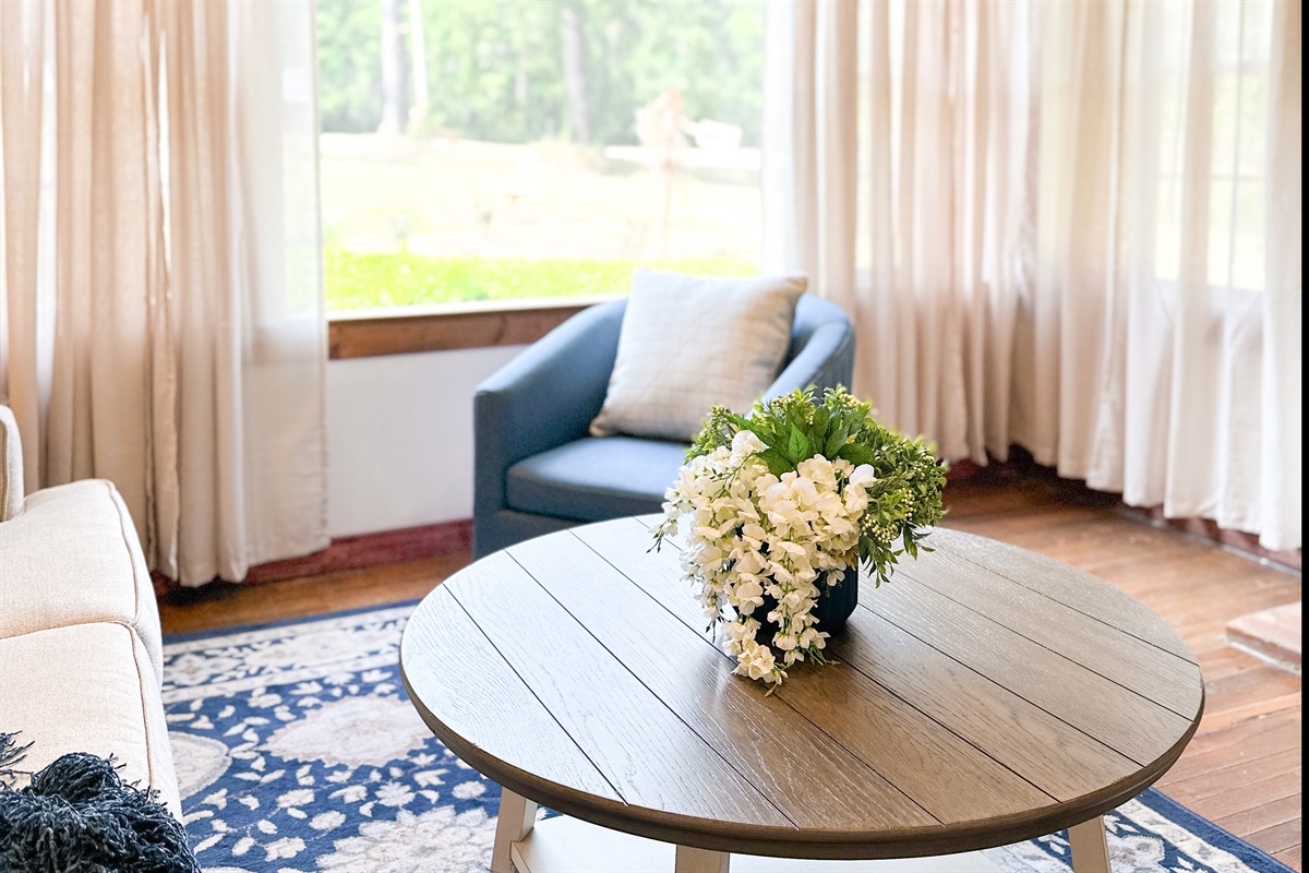 Living Room with Small Town Charm. Large windows looking at country side.