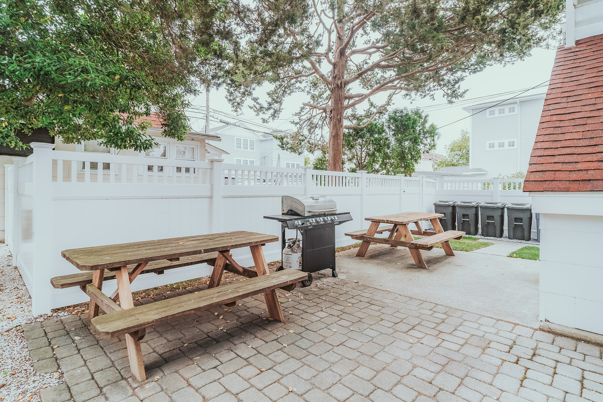 Paver Patio Area Showing Picnic Tables, Outdoor BBQ Grill, and Trash Storage Station