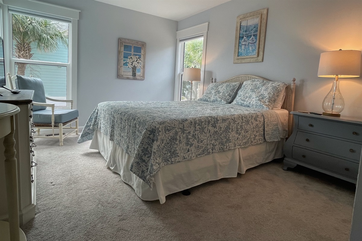 One of two main floor guest rooms, each featuring a queen bed, and ocean view. 