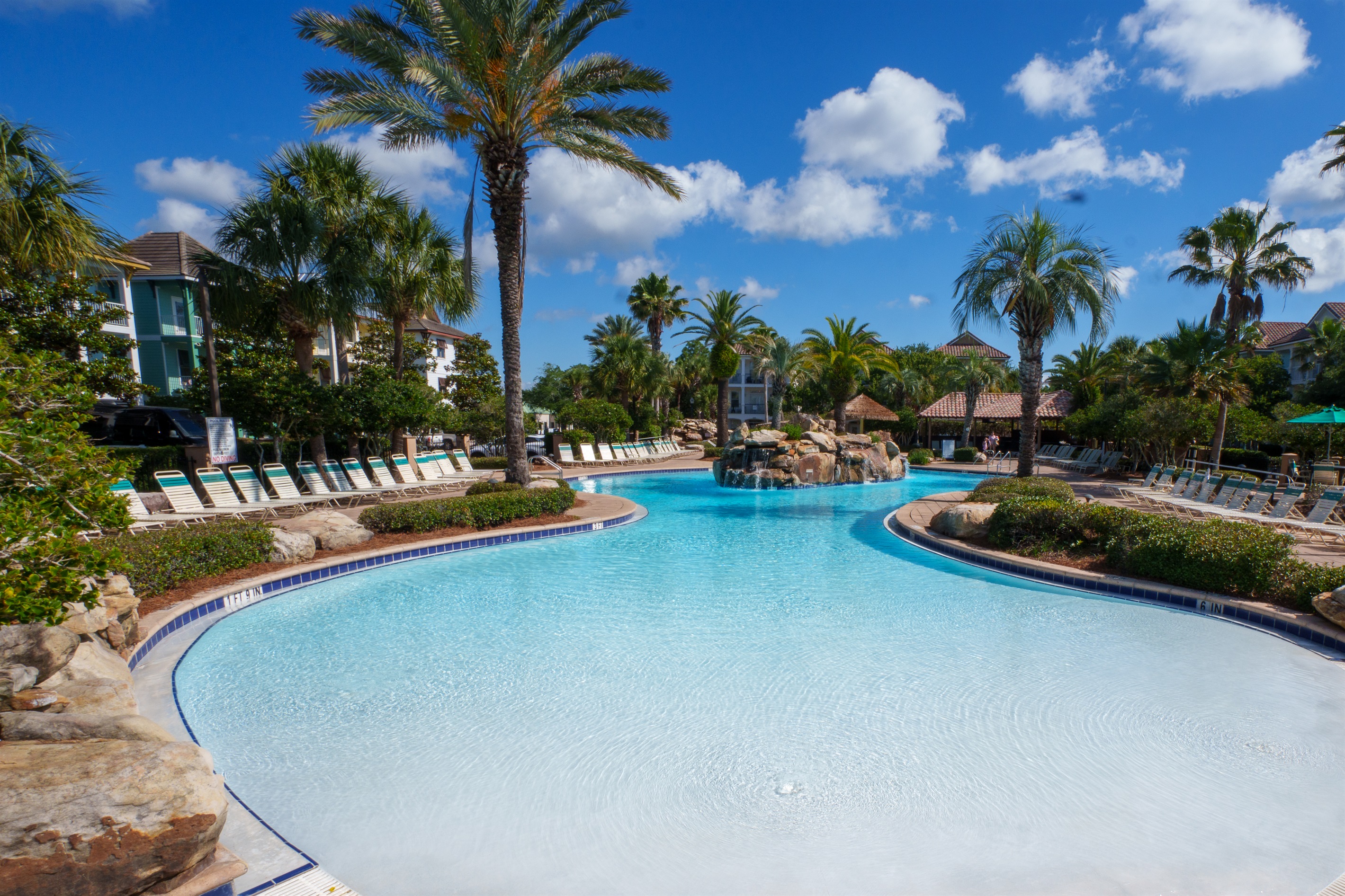 Large resort pool with plenty of lounge seating and sunny coastal vibes