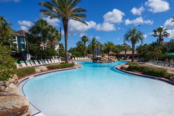 Large resort pool with plenty of lounge seating and sunny coastal vibes