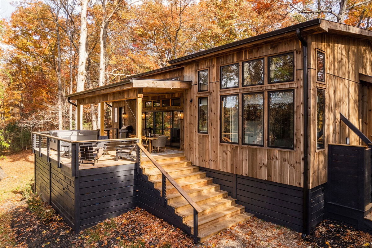 A full view of the deck, complete with a hot tub and cozy seating for outdoor relaxation.