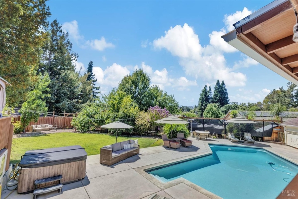 Backyard with pool, hot tub, and pool hosue bathroom.