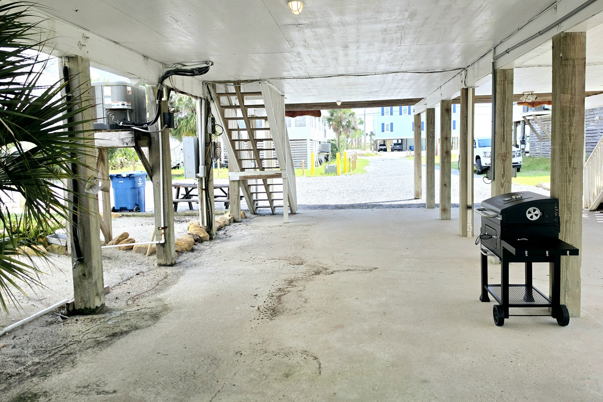 Covered parking with stairs up to the unit