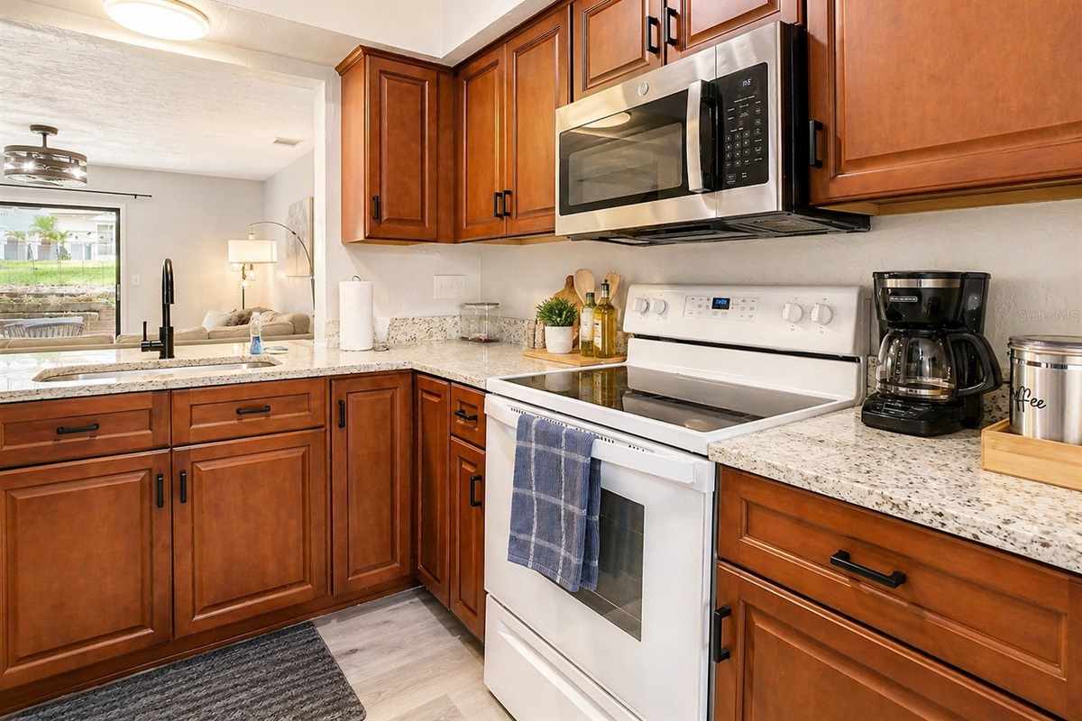 kitchen with trash compactor dish washer and large fridge with freezer and water dispenser