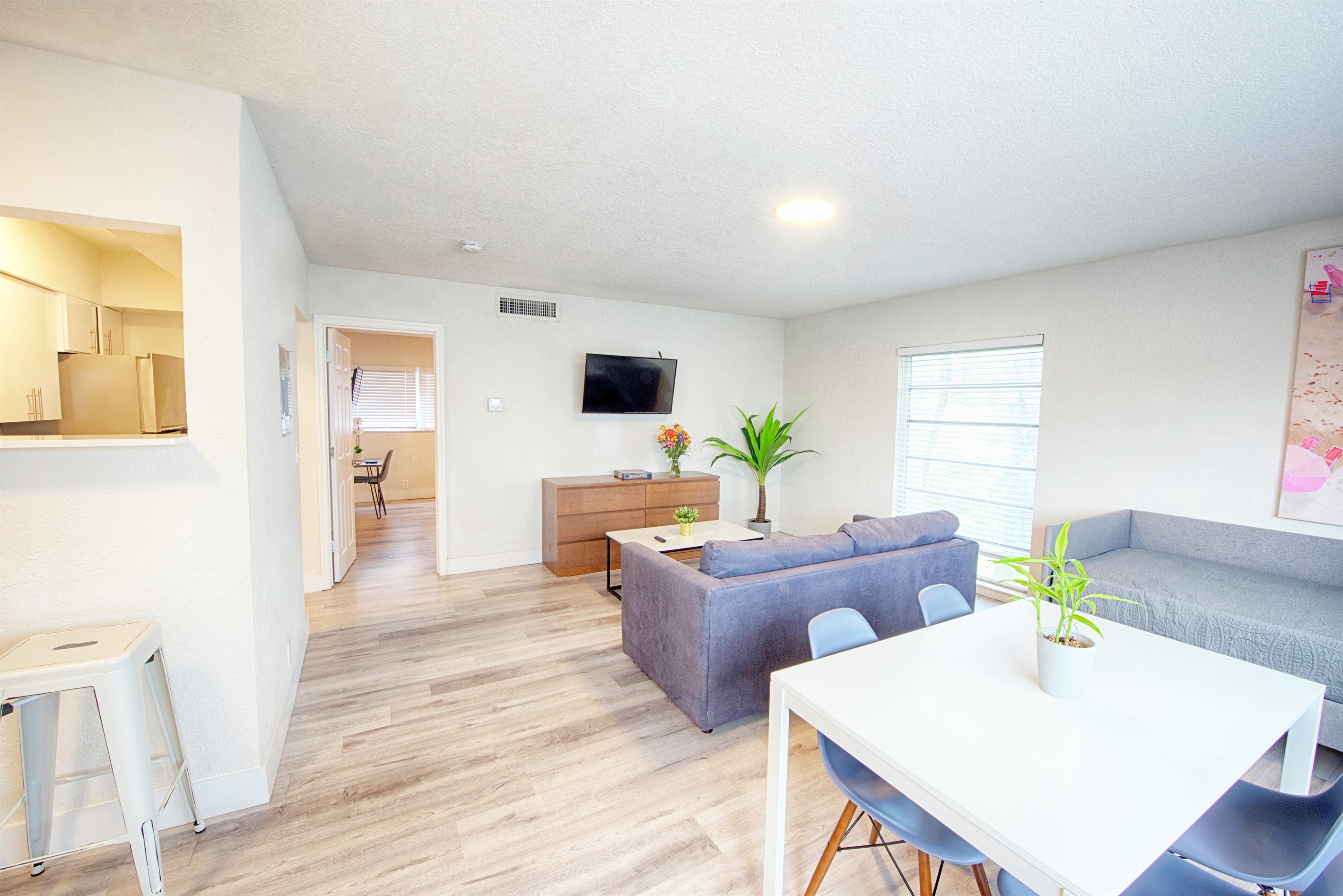 Alternative view of living room with 40" smart TV.  Entry of bedroom in view. Floor to ceiling window!