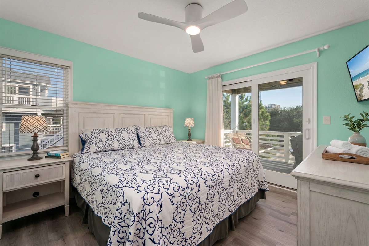 Spacious bedroom with fresh sea-inspired tones and stunning outdoor views.