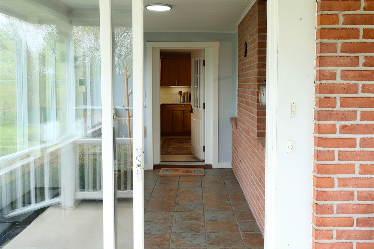 Entry to hold shoes, coats, jackets, luggage, coolers. Leads into kitchen