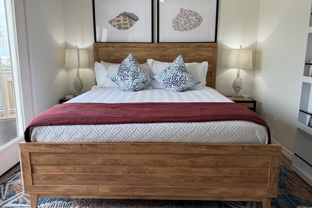 The Shell Bedroom Primary Suite! The is a king bedroom on the main level with a private full bathroom - tub and shower combo.
