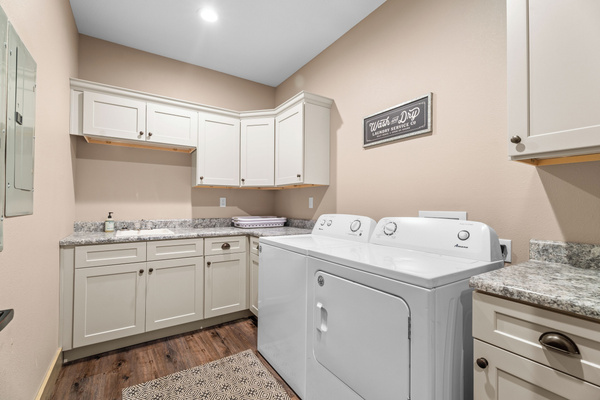 Main level laundry room. Full-size machines. Ironing station, clothes rack, and small sink for delicates. There's another laundry room on the lower level.