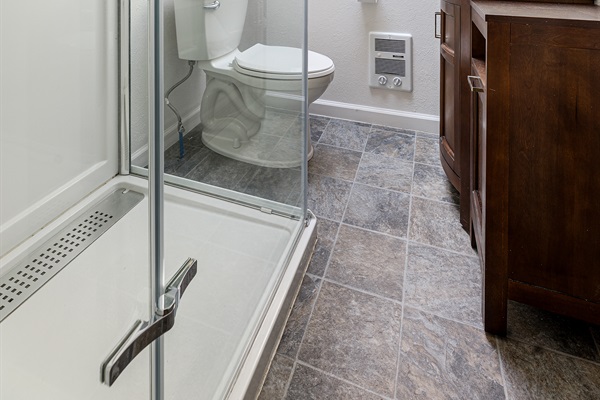 The upstairs bath has natural light and features a brand new rain shower head.