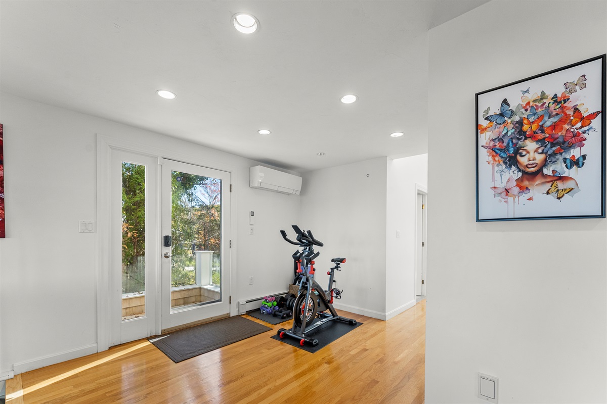 Stay fit with exercise equipment including a bike, weights, and yoga mat.