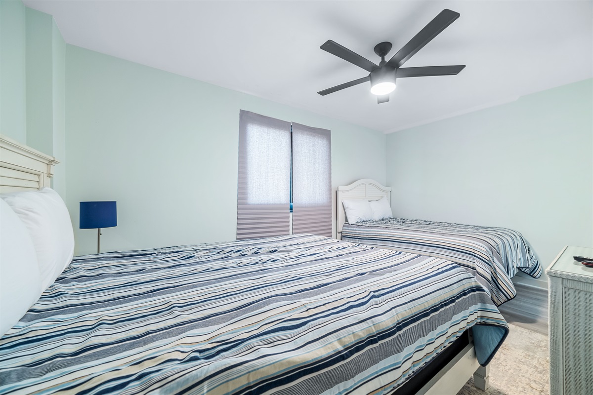 Bright and airy bedroom with 1 queen bed and 1 full bed, offering a comfortable and inviting space for guests.