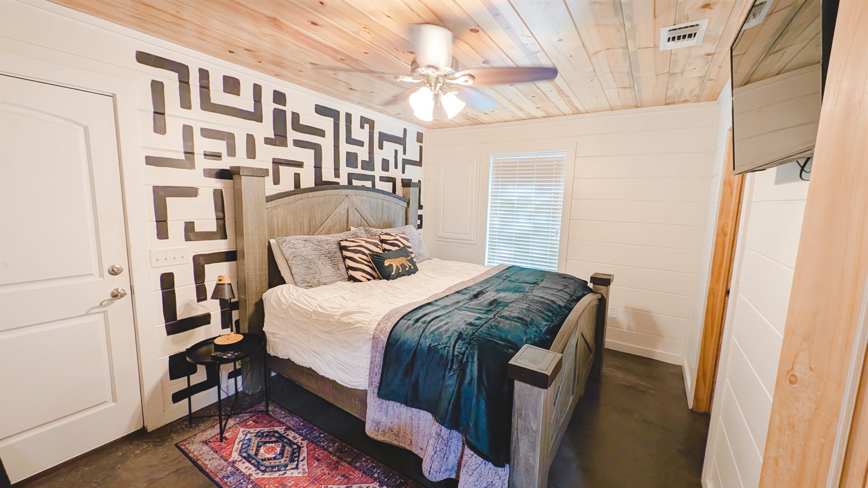 Boots + Beats | King bedroom 1 (sleeps 2), with an ensuite bathroom. This cabin sleeps up to eight guests total.