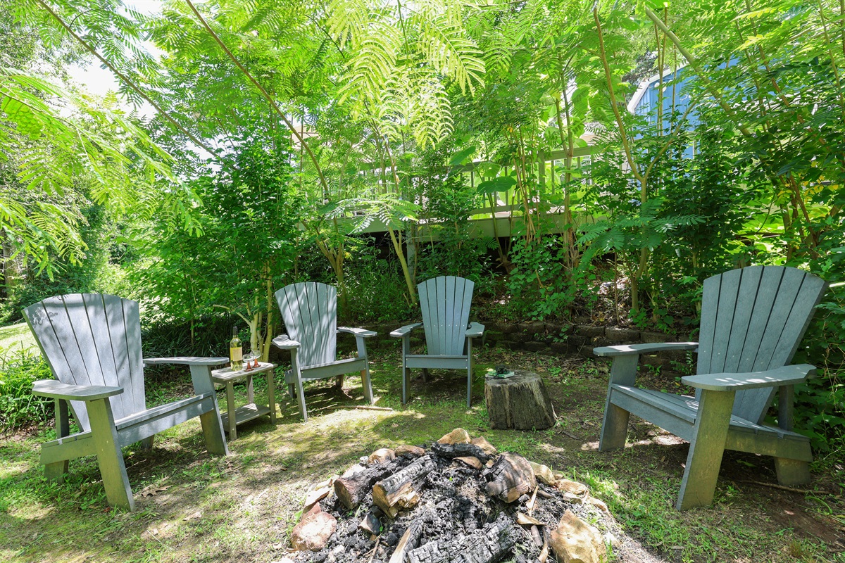 Fire pit area behind the house with river views