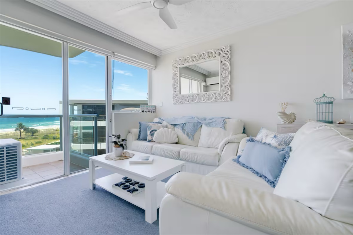 Living area with Beach views and balcony access