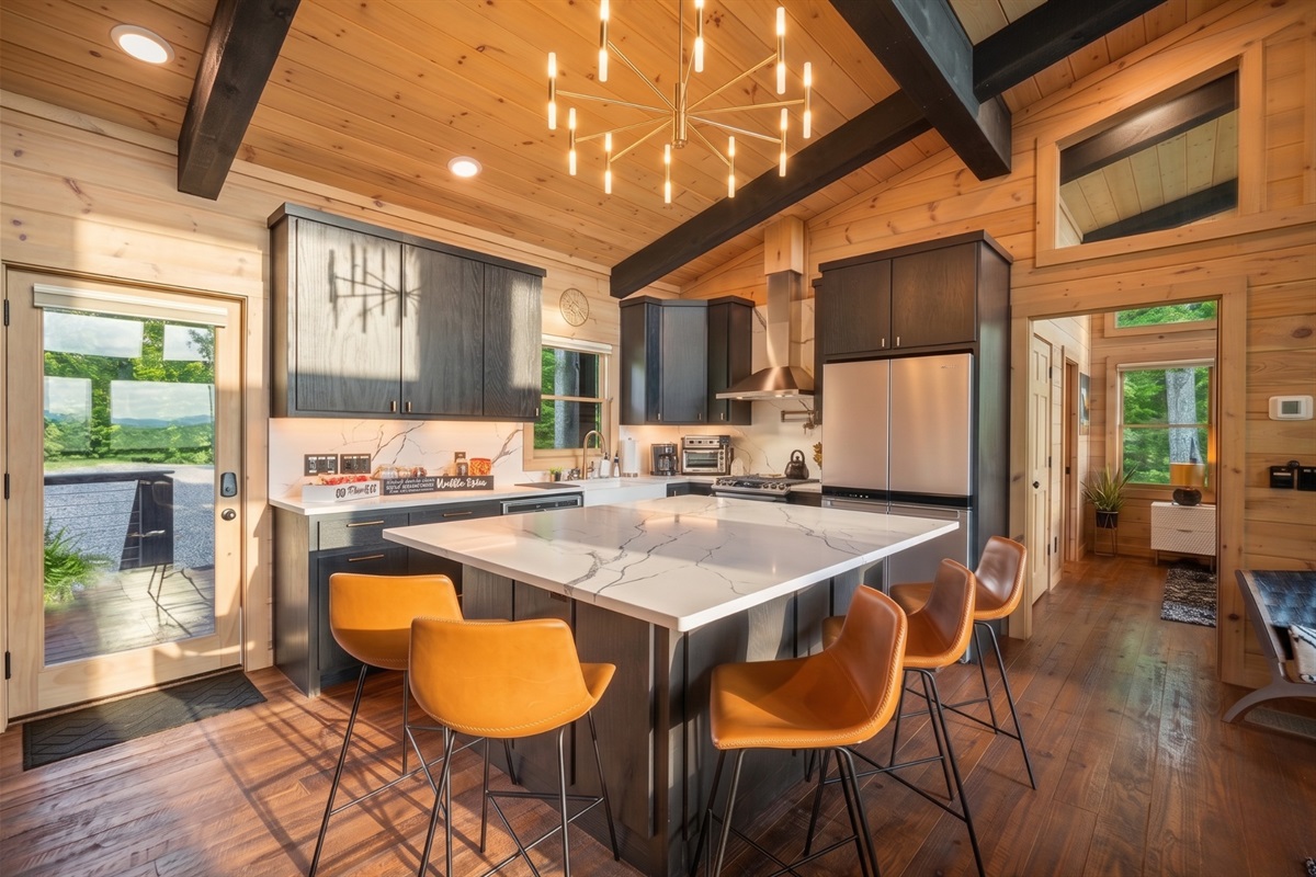 This sleek, modern kitchen with a large island is ideal for hosting and enjoying time with family and friends.