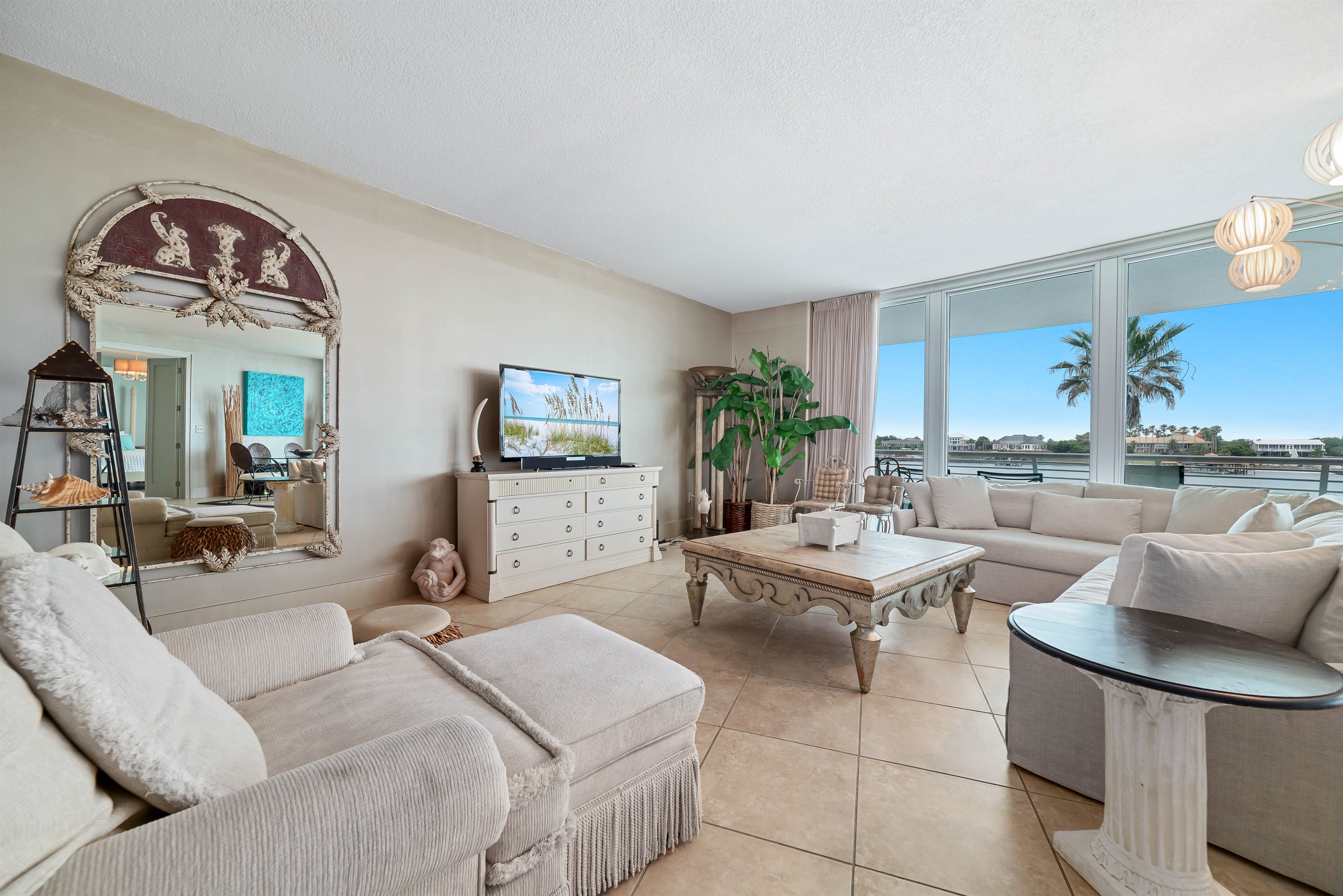 Experience the epitome of coastal living in this beautifully designed living room. Featuring plush furnishings, a serene color palette, and expansive views, this space offers a tranquil retreat for residents and guests alike.